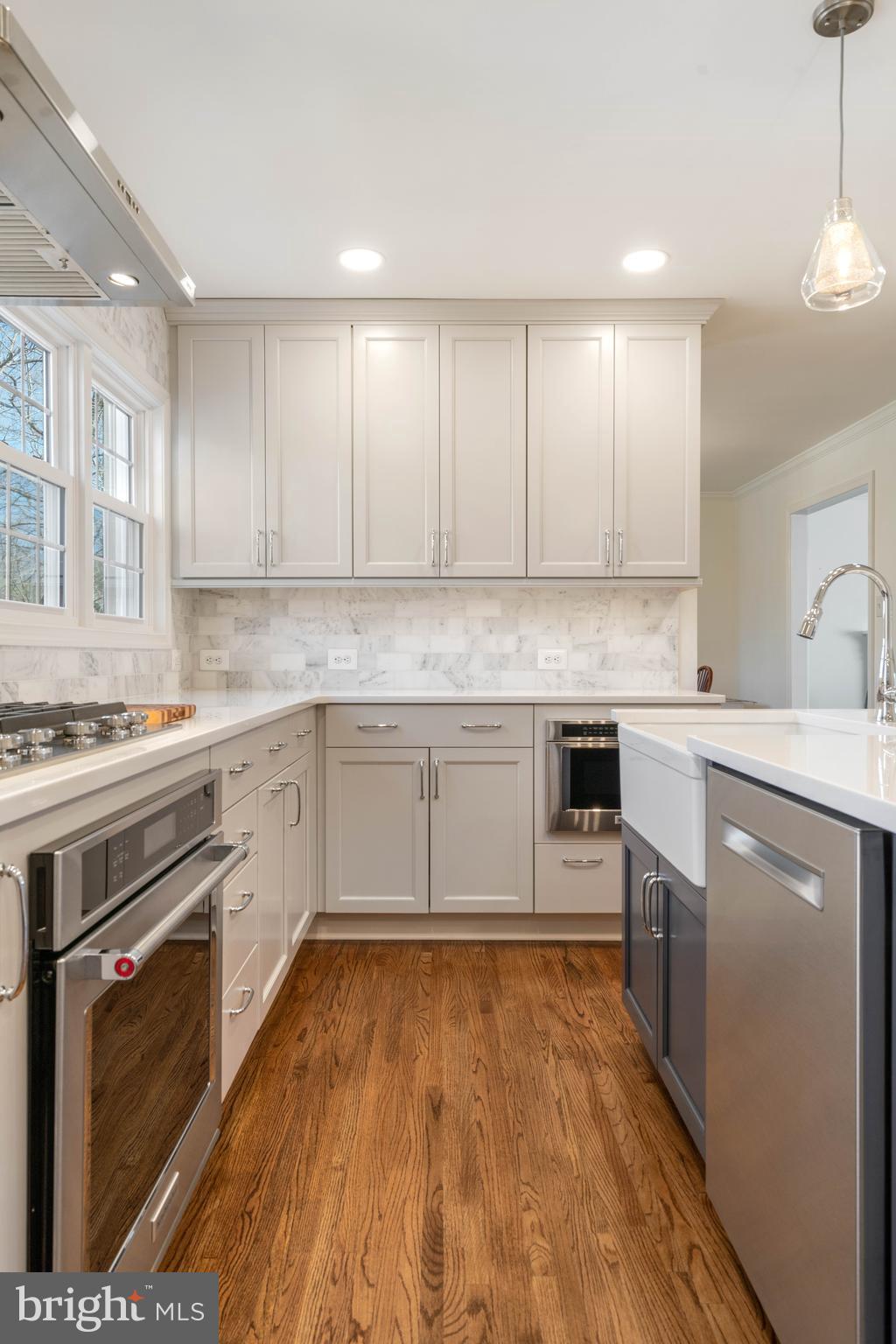 6600 Kensal Court Springfield, VA 22152 - Photo 6 of 43 a kitchen with a stove top oven sink and cabinets