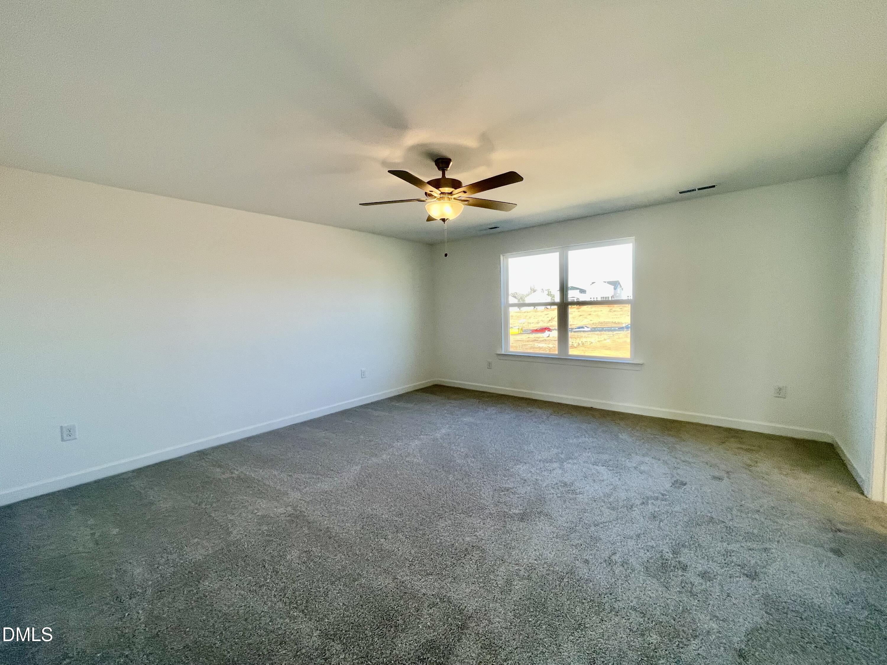 229 Sprenger Street Garner, NC 27529 - Photo 13 of 37 an empty room with windows and fan