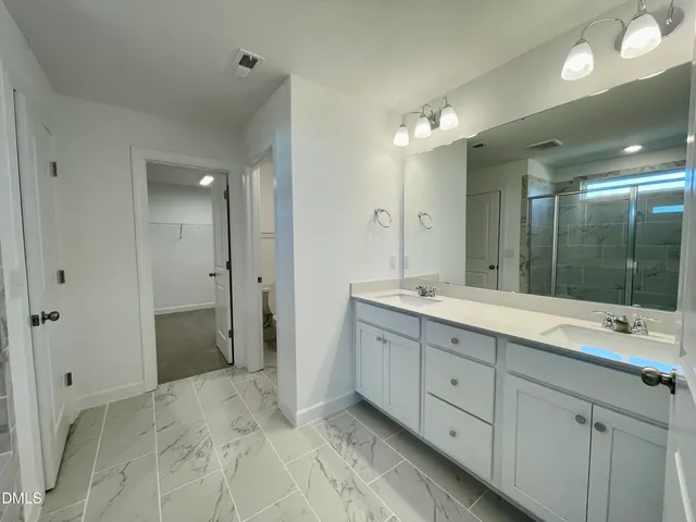 a bathroom with a double vanity sink mirror and double