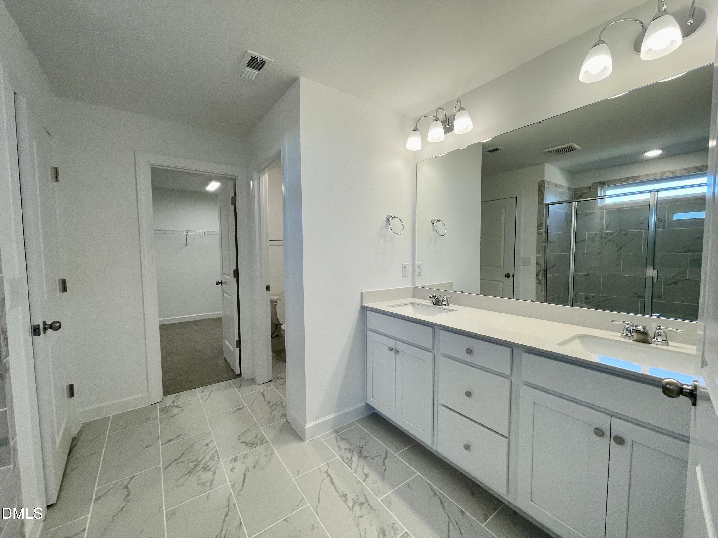 229 Sprenger Street Garner, NC 27529 - Photo 14 of 37 a bathroom with a double vanity sink mirror and double