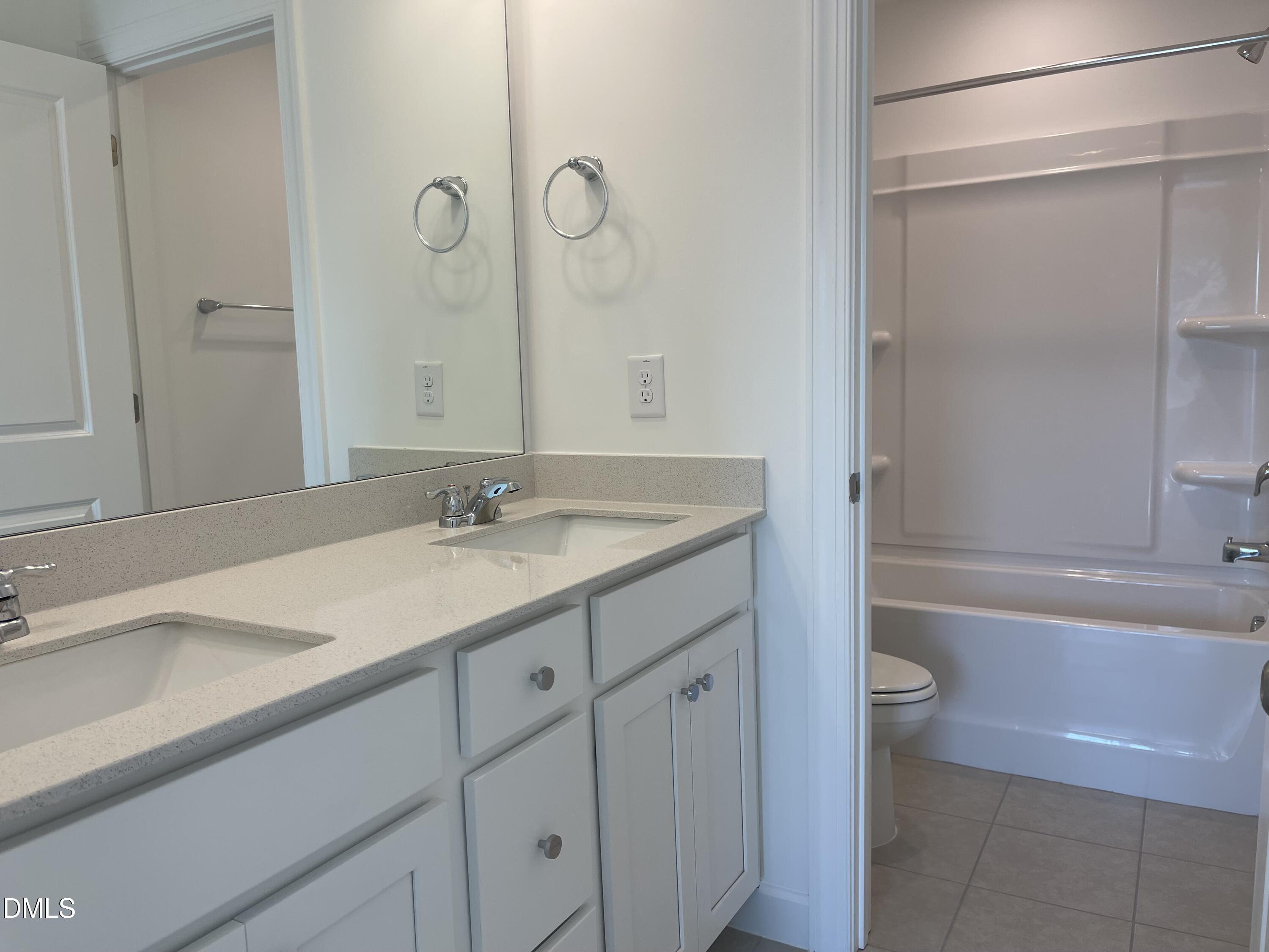 229 Sprenger Street Garner, NC 27529 - Photo 20 of 37 a bathroom with a granite countertop sink a toilet and shower