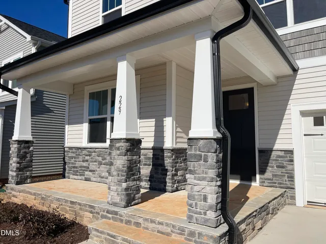 a front view of a house with large windows