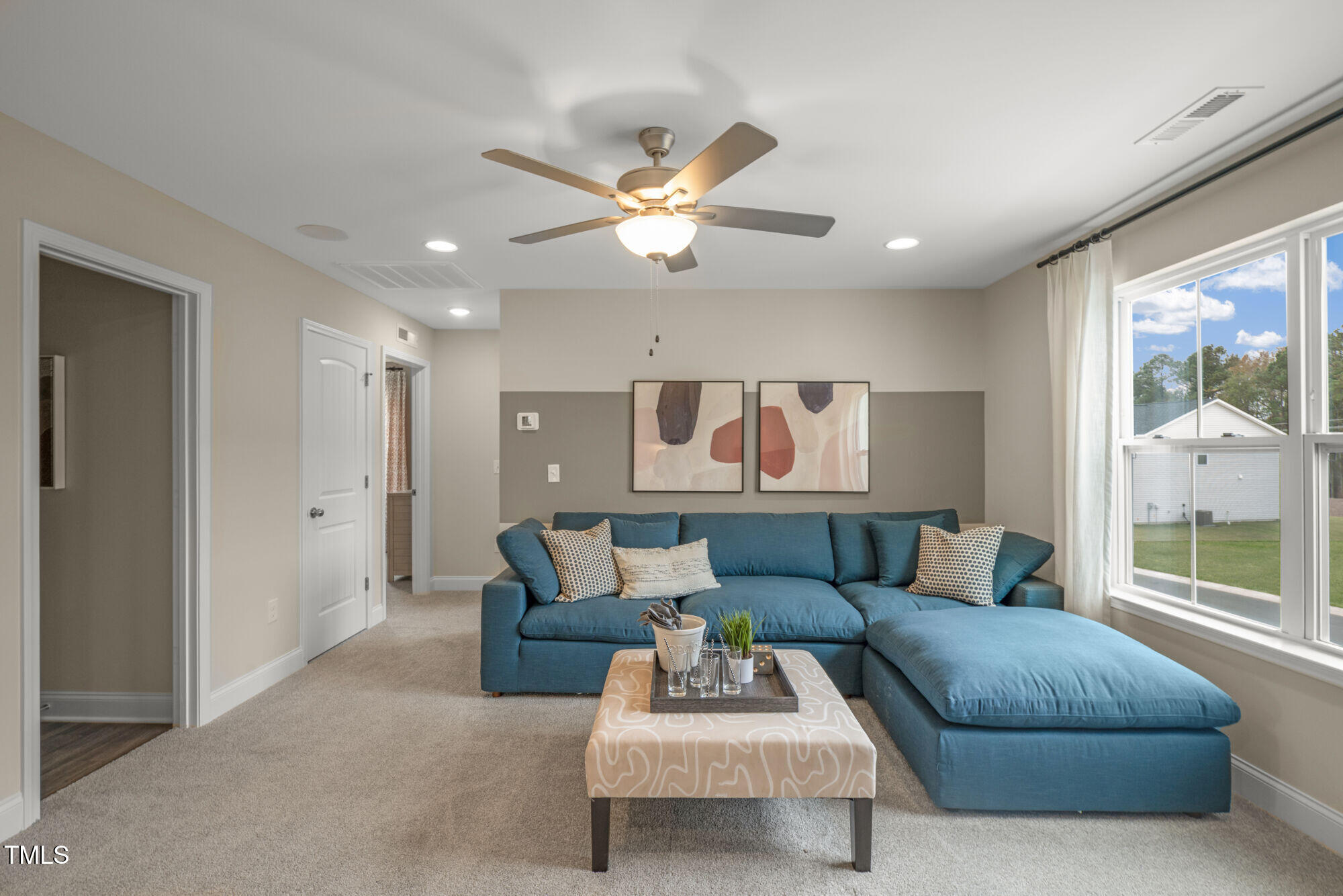 229 Sprenger Street Garner, NC 27529 - Photo 27 of 37 a living room with furniture and a large window