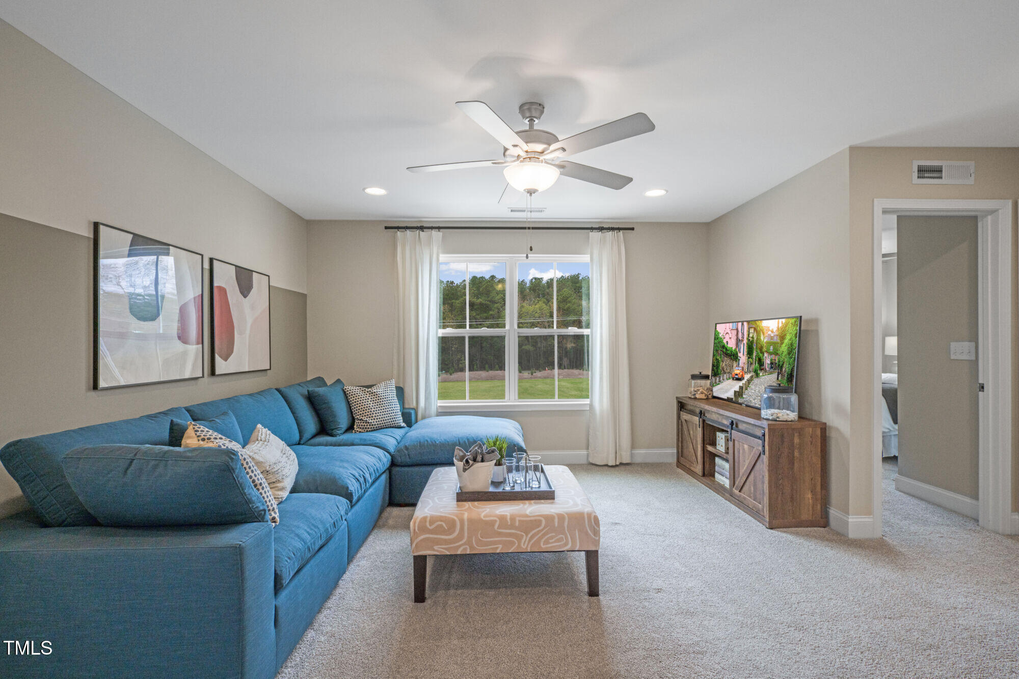 229 Sprenger Street Garner, NC 27529 - Photo 28 of 37 a living room with furniture and a large window