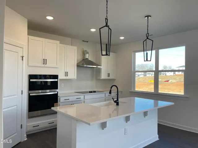 a kitchen with stainless steel appliances a sink stove and cabinets