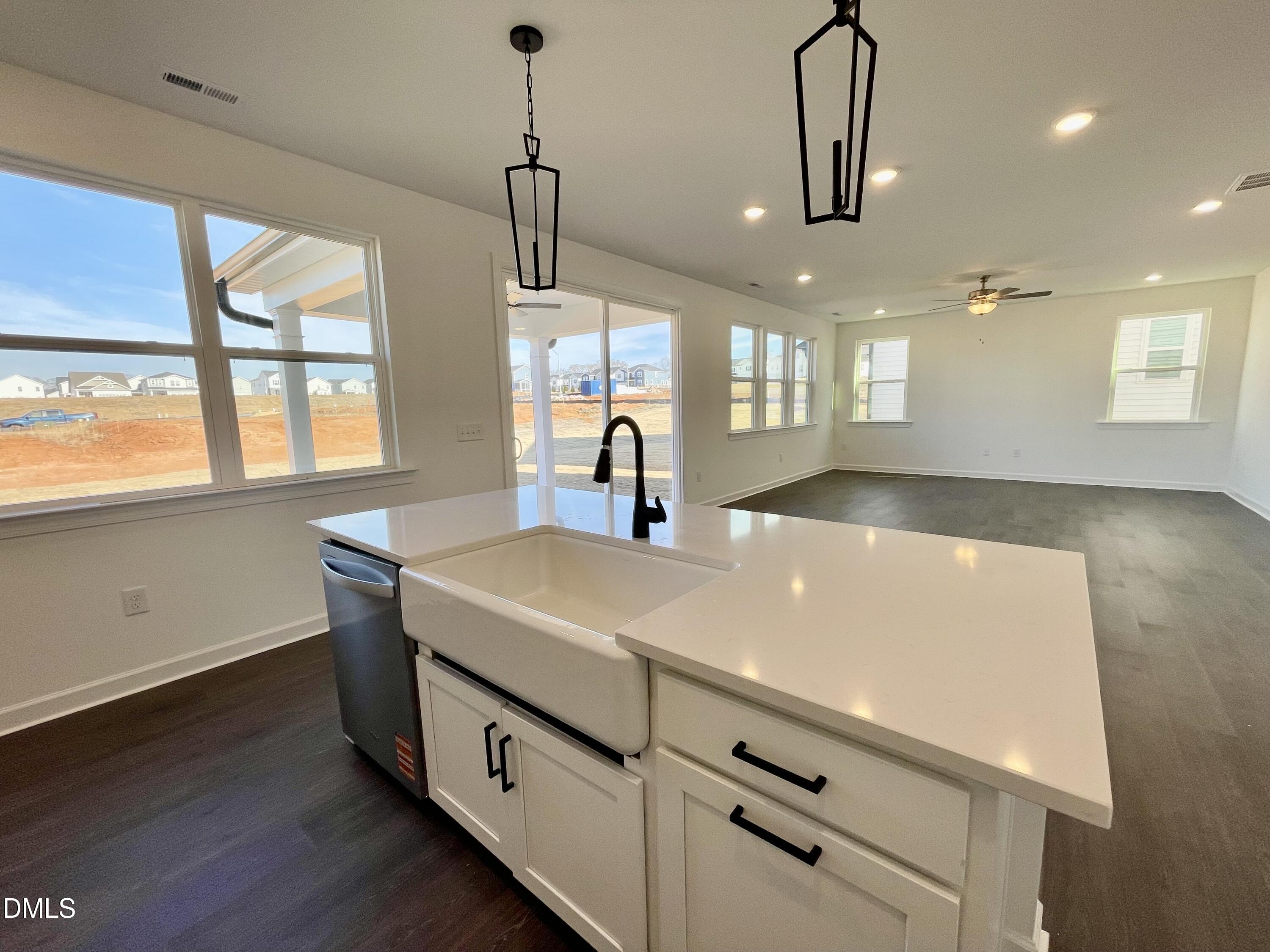 229 Sprenger Street Garner, NC 27529 - Photo 6 of 37 a kitchen with a sink a window and wooden floor