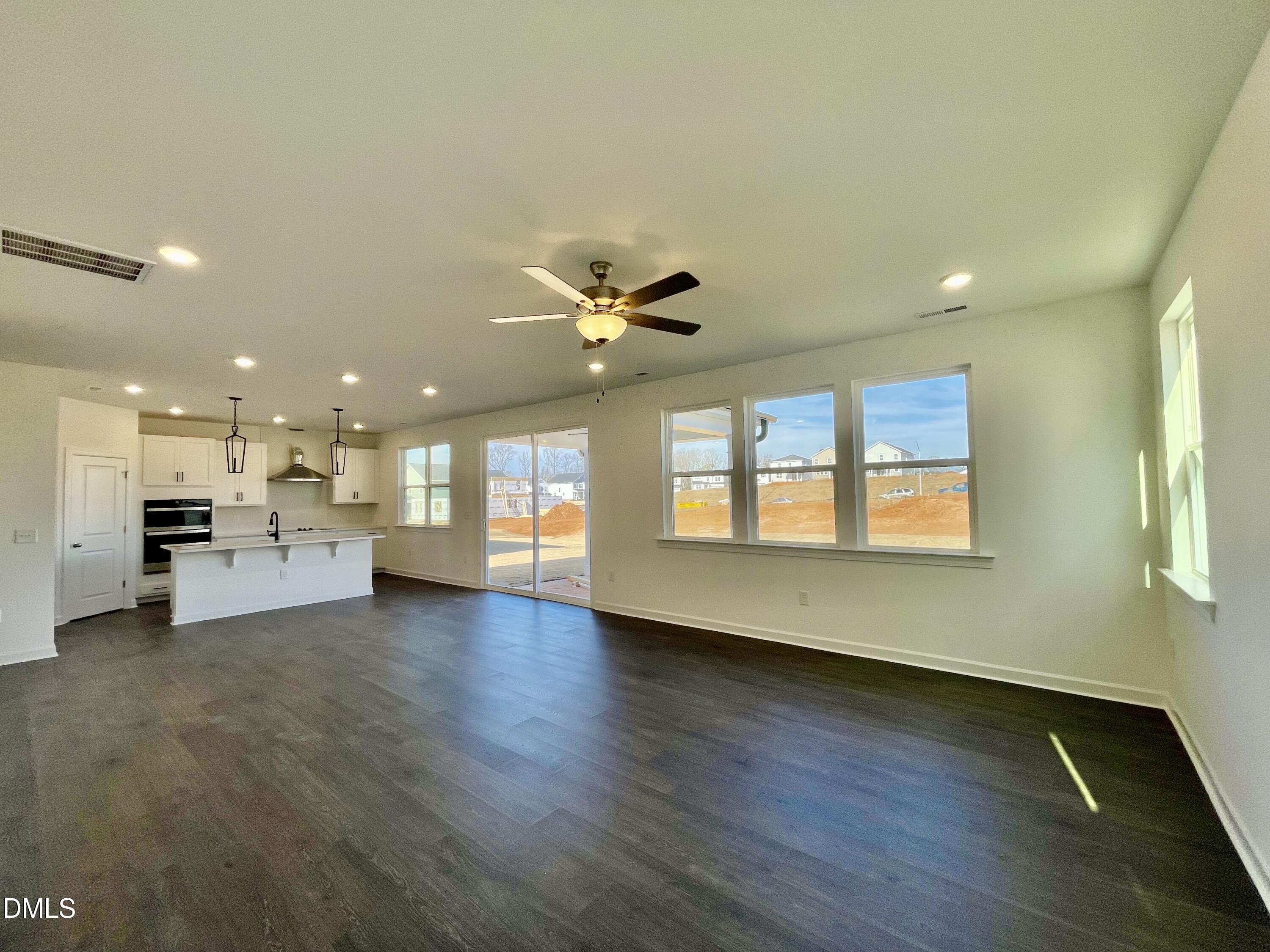 229 Sprenger Street Garner, NC 27529 - Photo 7 of 37 a view of an empty room with window and wooden floor
