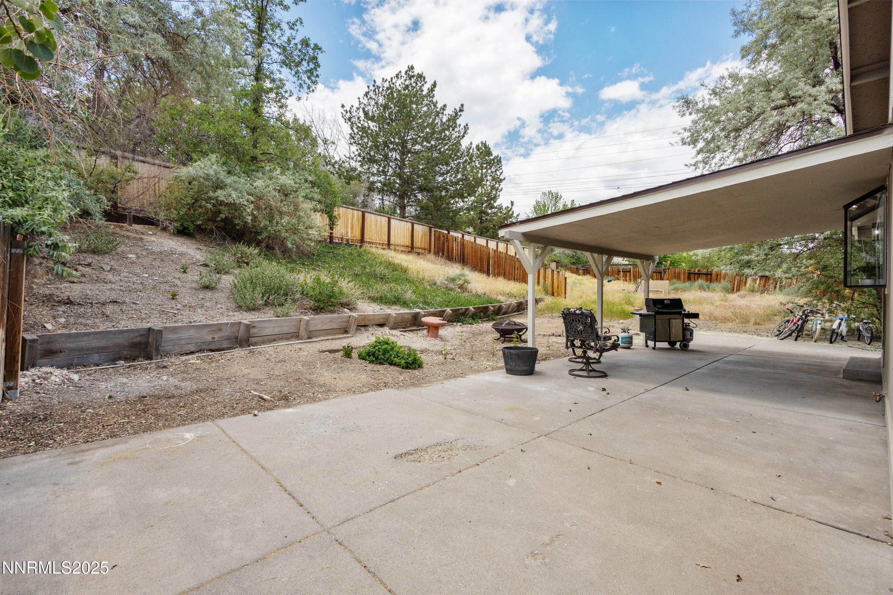 5809 Sydney Court Reno, NV 89523 - Photo 22 of 28 a view of a patio with table and chairs under an umbrella