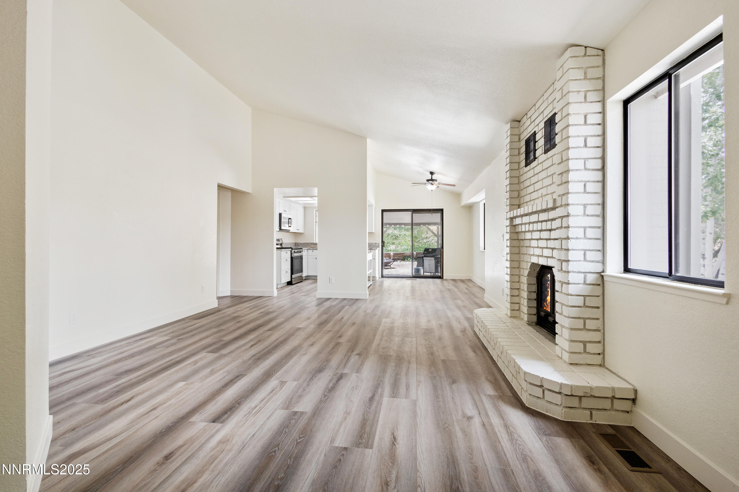 5809 Sydney Court Reno, NV 89523 - Photo 3 of 28 a view of a living room hardwood floor and a kitchen with wooden floor