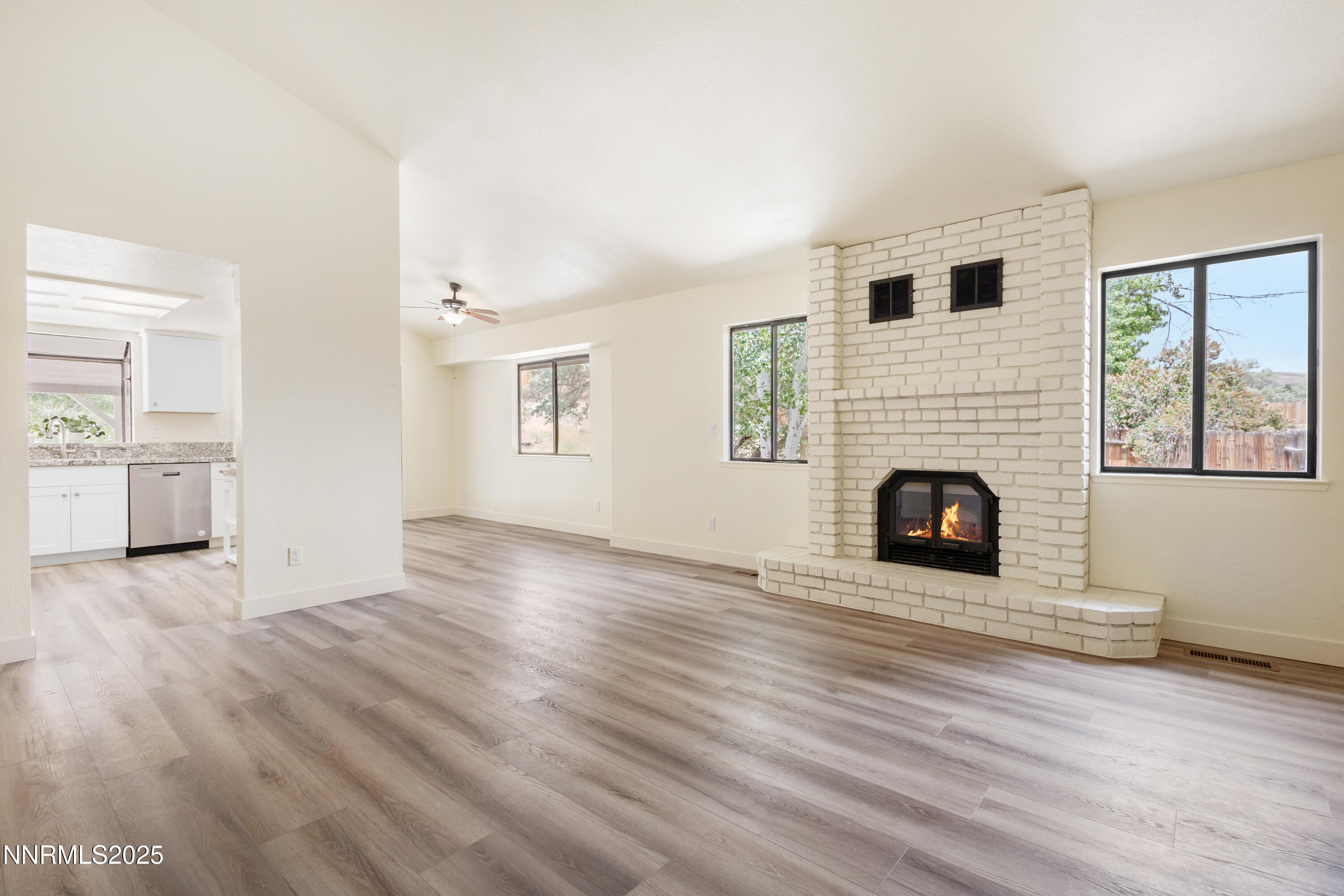 5809 Sydney Court Reno, NV 89523 - Photo 4 of 28 a view of empty room with wooden floor and fireplace