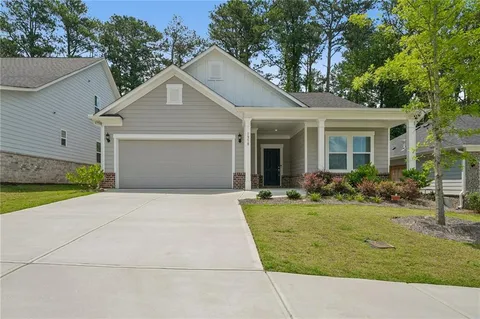 a front view of house with yard and green space