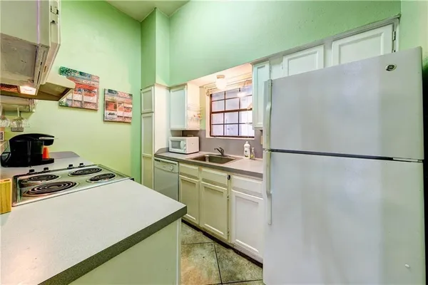 a kitchen with a refrigerator and a stove