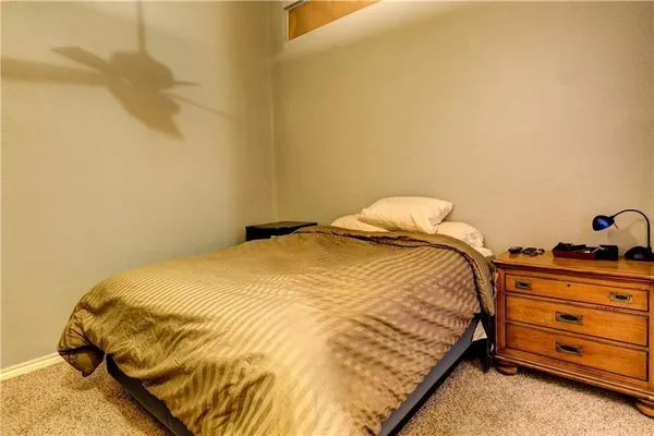 a bedroom with a bed and dresser
