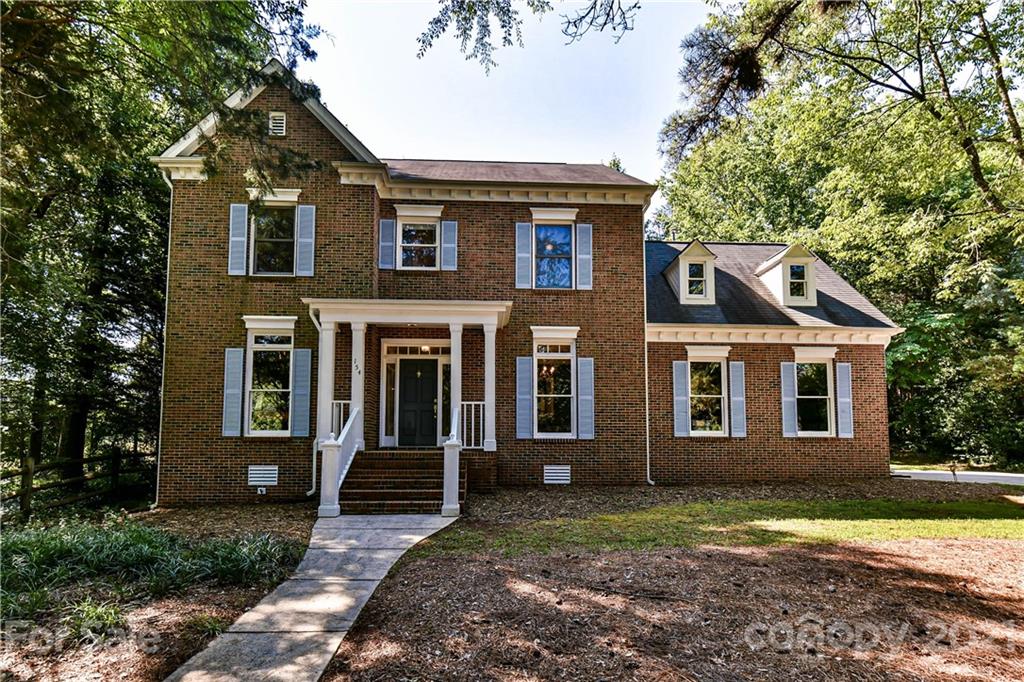 154 Morrison Hill Road Davidson, NC 28036 - Photo 1 of 23 a front view of a house with garden