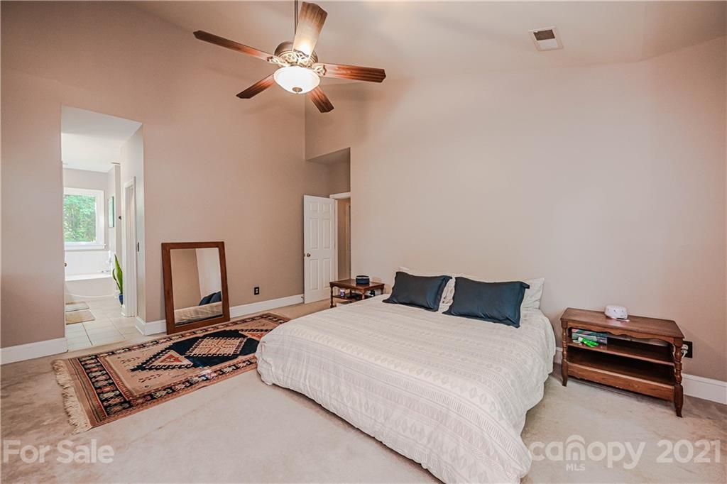 154 Morrison Hill Road Davidson, NC 28036 - Photo 12 of 23 a bedroom with a bed ceiling fan and a window