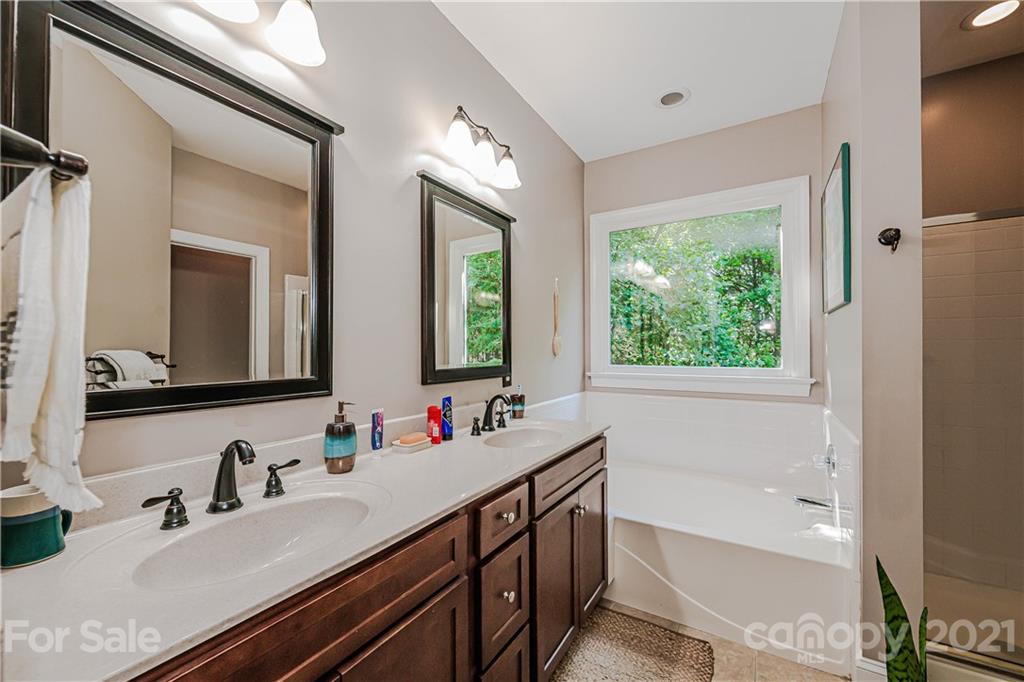 154 Morrison Hill Road Davidson, NC 28036 - Photo 13 of 23 a bathroom with a tub double sink window and mirror