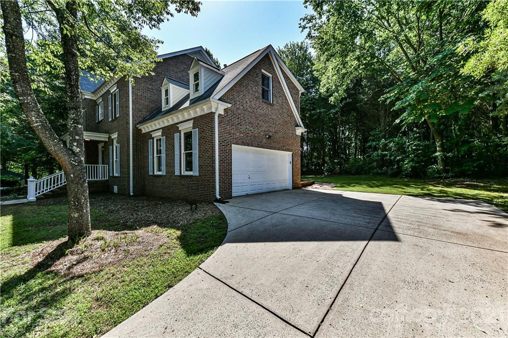 154 Morrison Hill Road Davidson, NC 28036 - Photo 22 of 23 a front view of a house with a yard and a garage