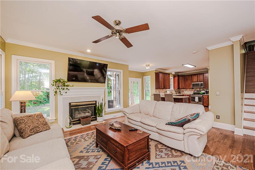 154 Morrison Hill Road Davidson, NC 28036 - Photo 6 of 23 a living room with furniture a fireplace and a flat screen tv