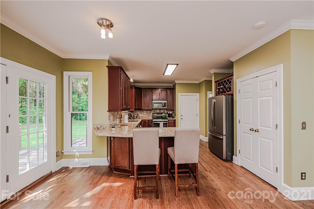 154 Morrison Hill Road Davidson, NC 28036 - Photo 8 of 23 a view of a kitchen with refrigerator and wooden floor