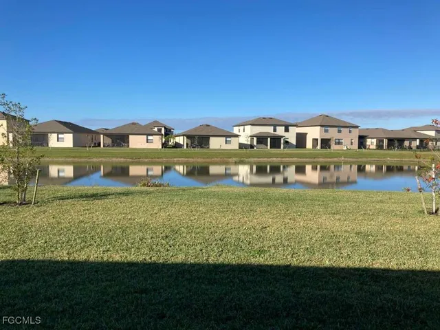 an aerial view of a house with a garden and lake view