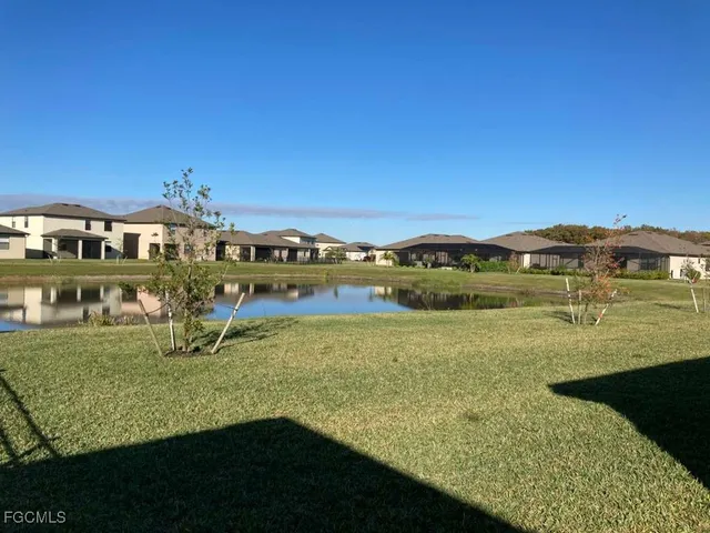 an aerial view of a house with a garden and lake view