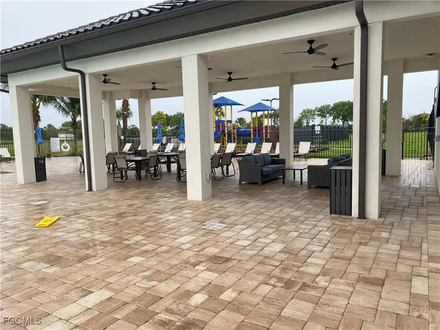 a view of a tennis ground with large trees
