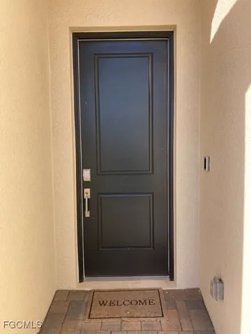 a bathroom with a granite countertop sink a mirror and a shower