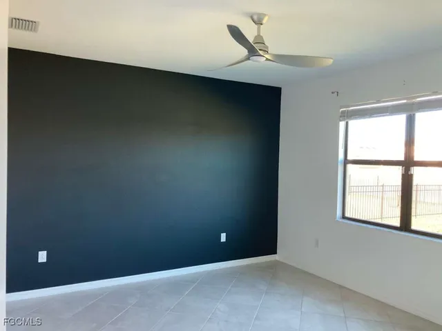 a bathroom with a granite countertop toilet sink and vanity