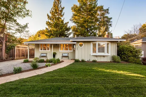 a view of a house with a yard and plants