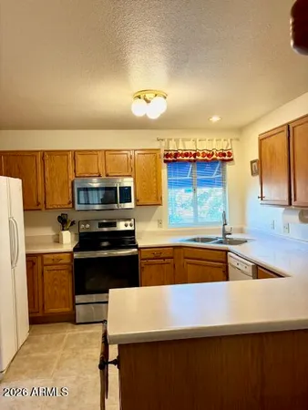 a kitchen with stainless steel appliances a sink and a refrigerator