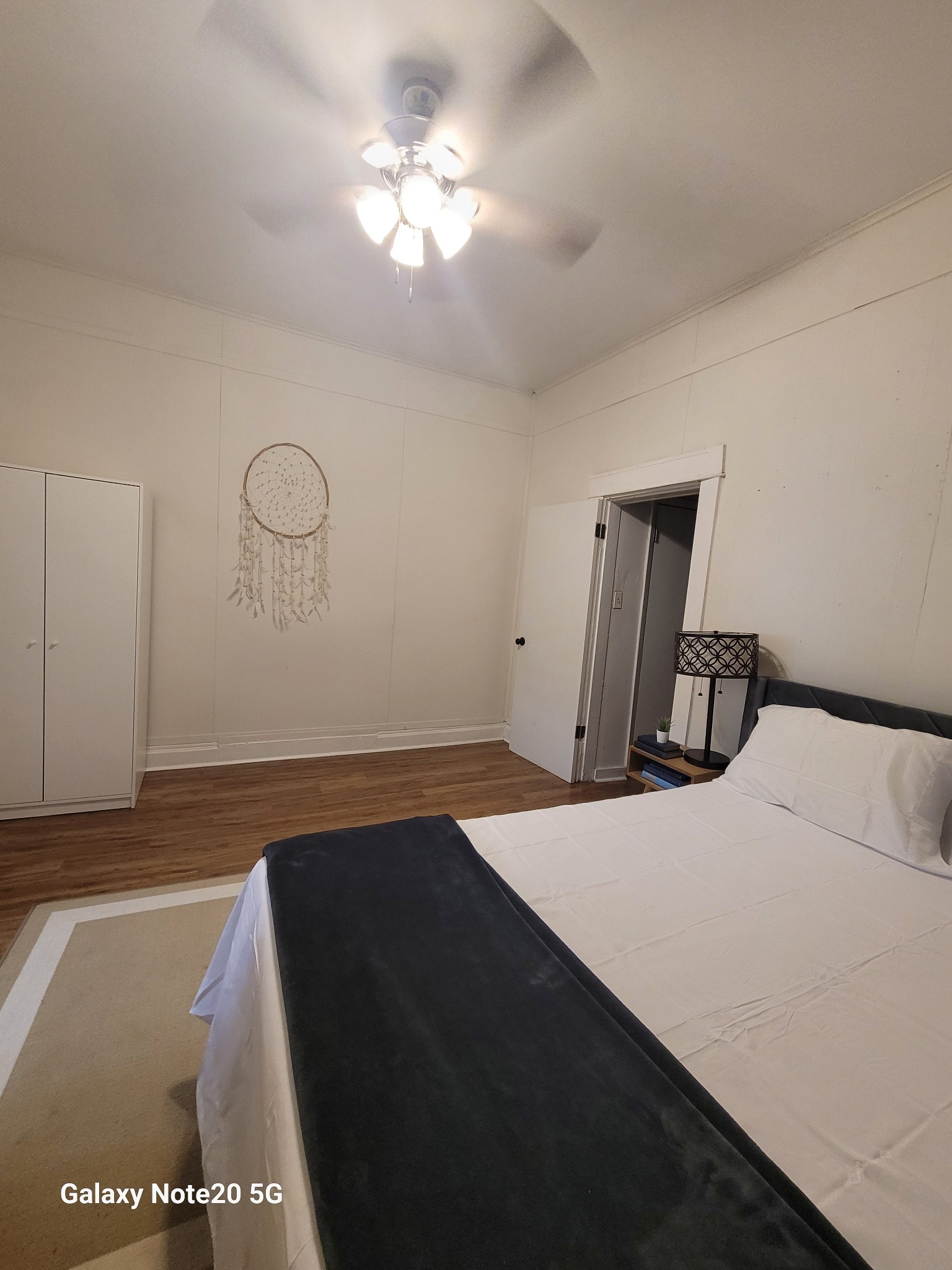 426 West King Street Jackson, TN 38301 - Photo 14 of 17 a bedroom with a bed and a chandelier