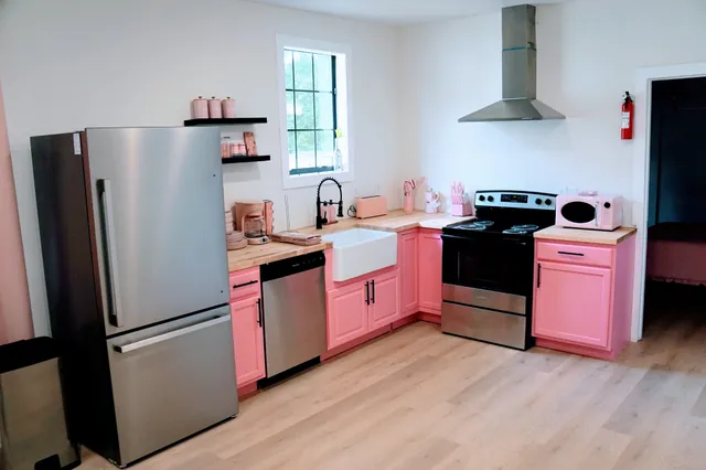 a kitchen with stainless steel appliances granite countertop a refrigerator stove and sink