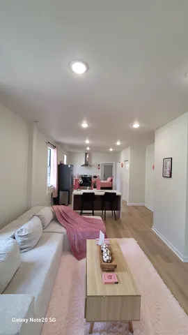 a living room with furniture a coffee table and kitchen view