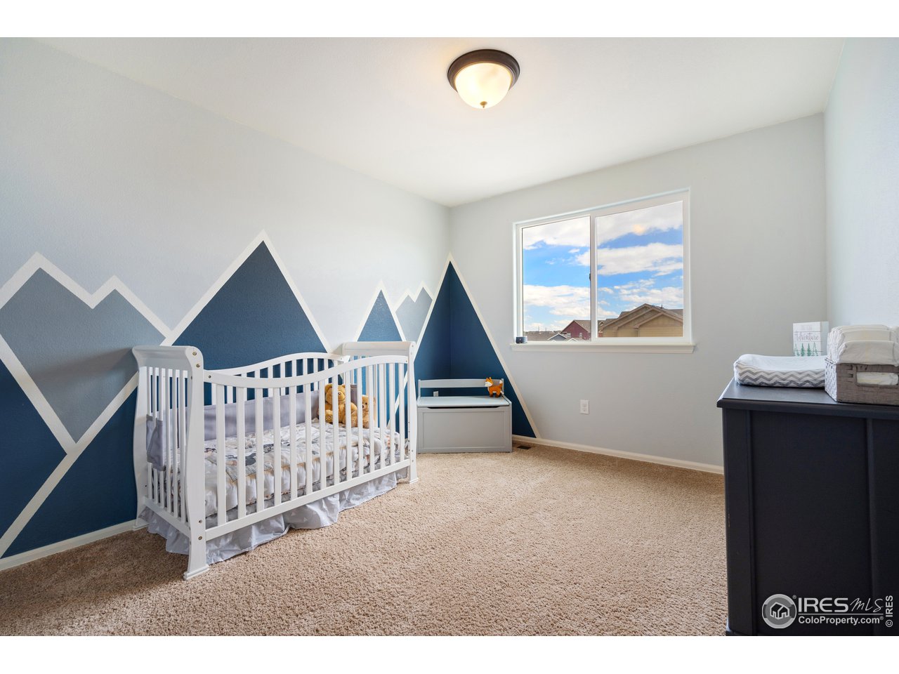 8705 13th St Road Greeley, CO 80634 - Photo 25 of 40 2nd bedroom with alpine wall mural, located upstairs.