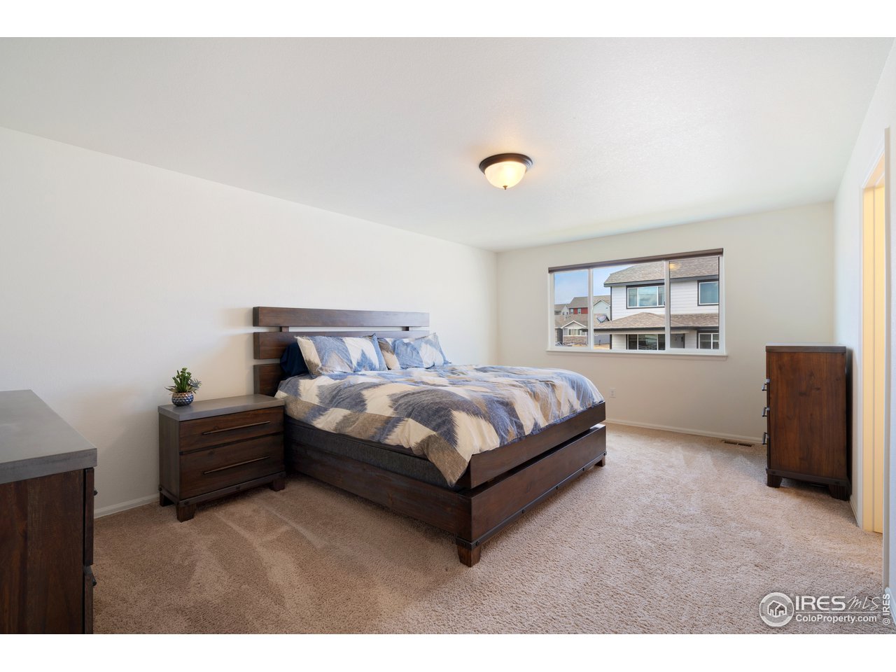 8705 13th St Road Greeley, CO 80634 - Photo 5 of 40 Large main bedroom located upstairs. It has an attached full bathroom and large walk in closet.