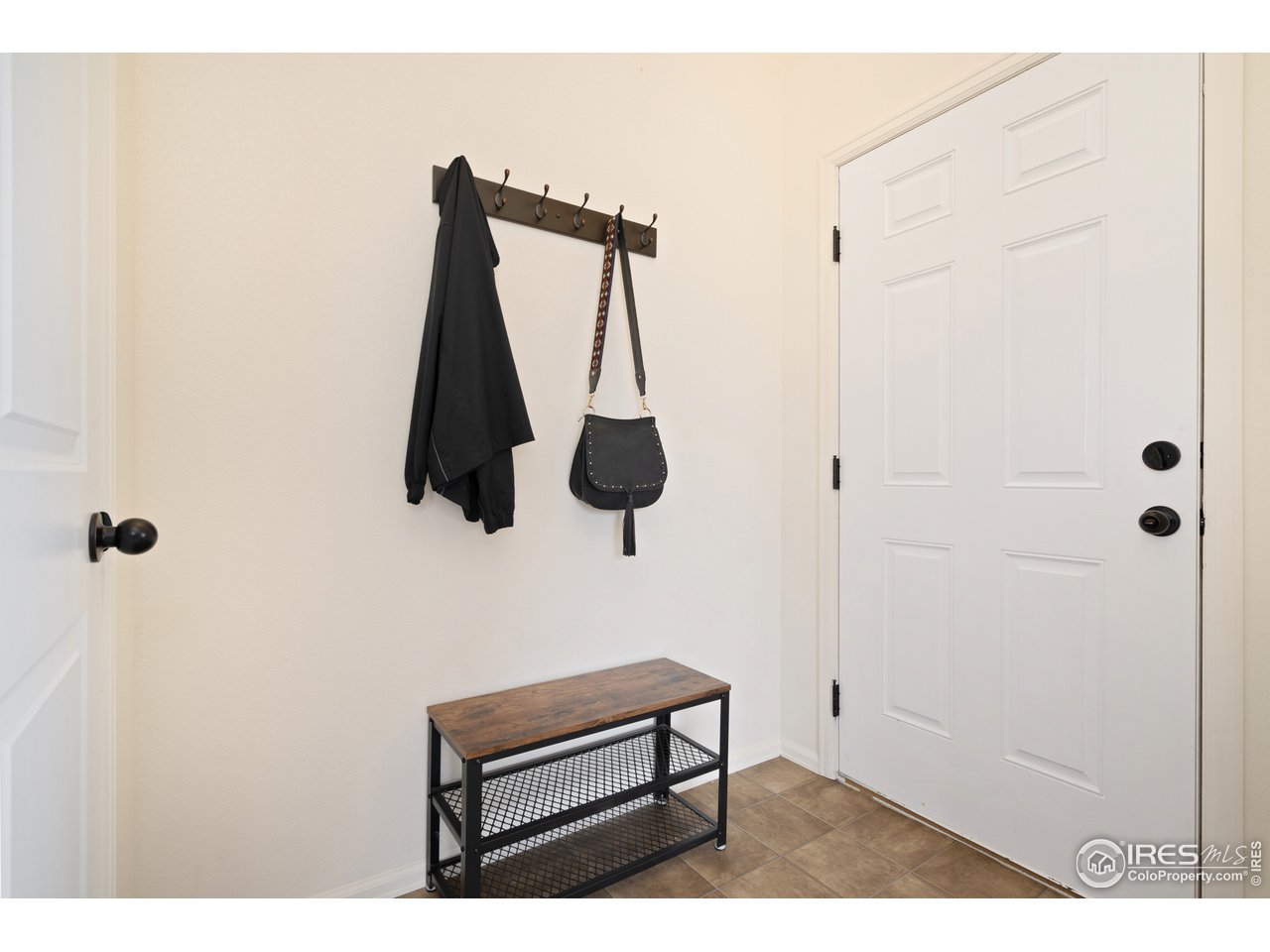 8705 13th St Road Greeley, CO 80634 - Photo 9 of 40 Entrance way with coat closet and easy to clean laminate floors.