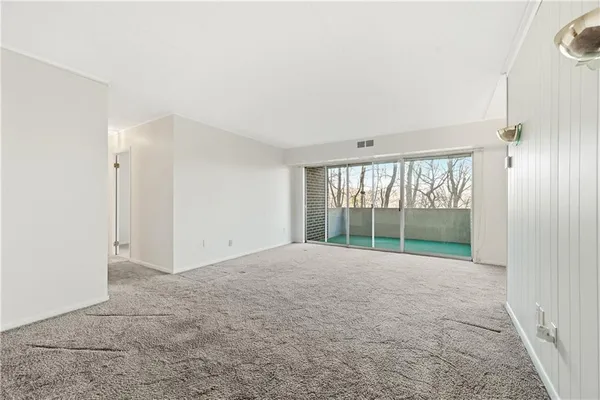 a view of an empty room with a window