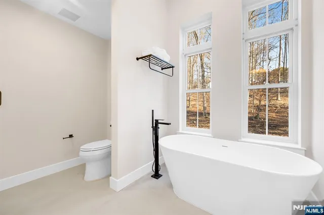 a white bath tub sitting next to a white toilet
