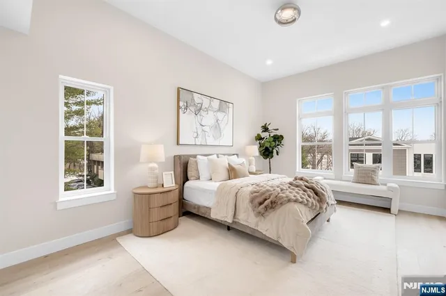 a bed room with a bed and a large window