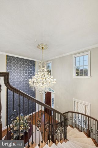 a bathroom with a granite countertop sink toilet a large mirror and a window