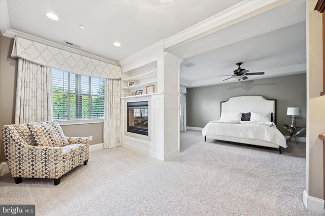 a view of a white house with a large windows and a yard