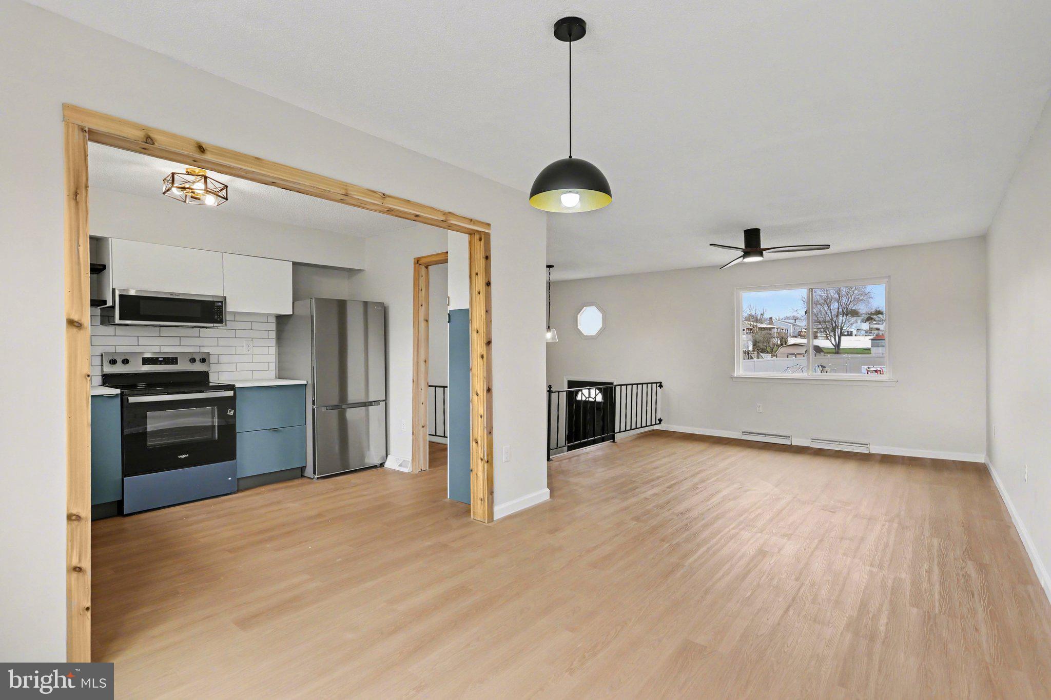 4273 Marlborough Road Dover, PA 17315 - Photo 10 of 29 a view of a kitchen with a sink stove refrigerator and wooden floor