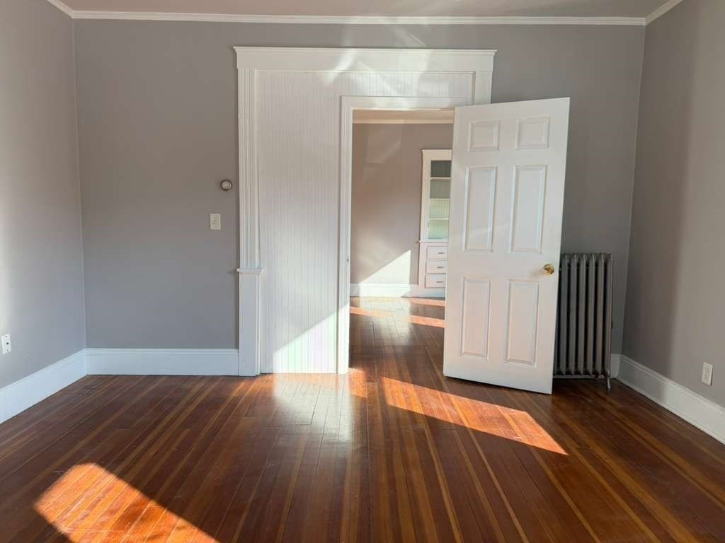 246 Rogers Street, Unit 1 Lowell, MA 01852 - Photo 4 of 17 a view of wooden floor in an empty room