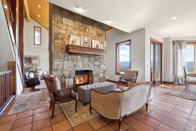 335 Bern Way Midway, UT 84049 - Photo 17 of 88 Stone fireplace with a substantial wood mantel, vaulted wood-paneled ceilings, warm-toned tile flooring, recessed lighting, and large windows with wood framing