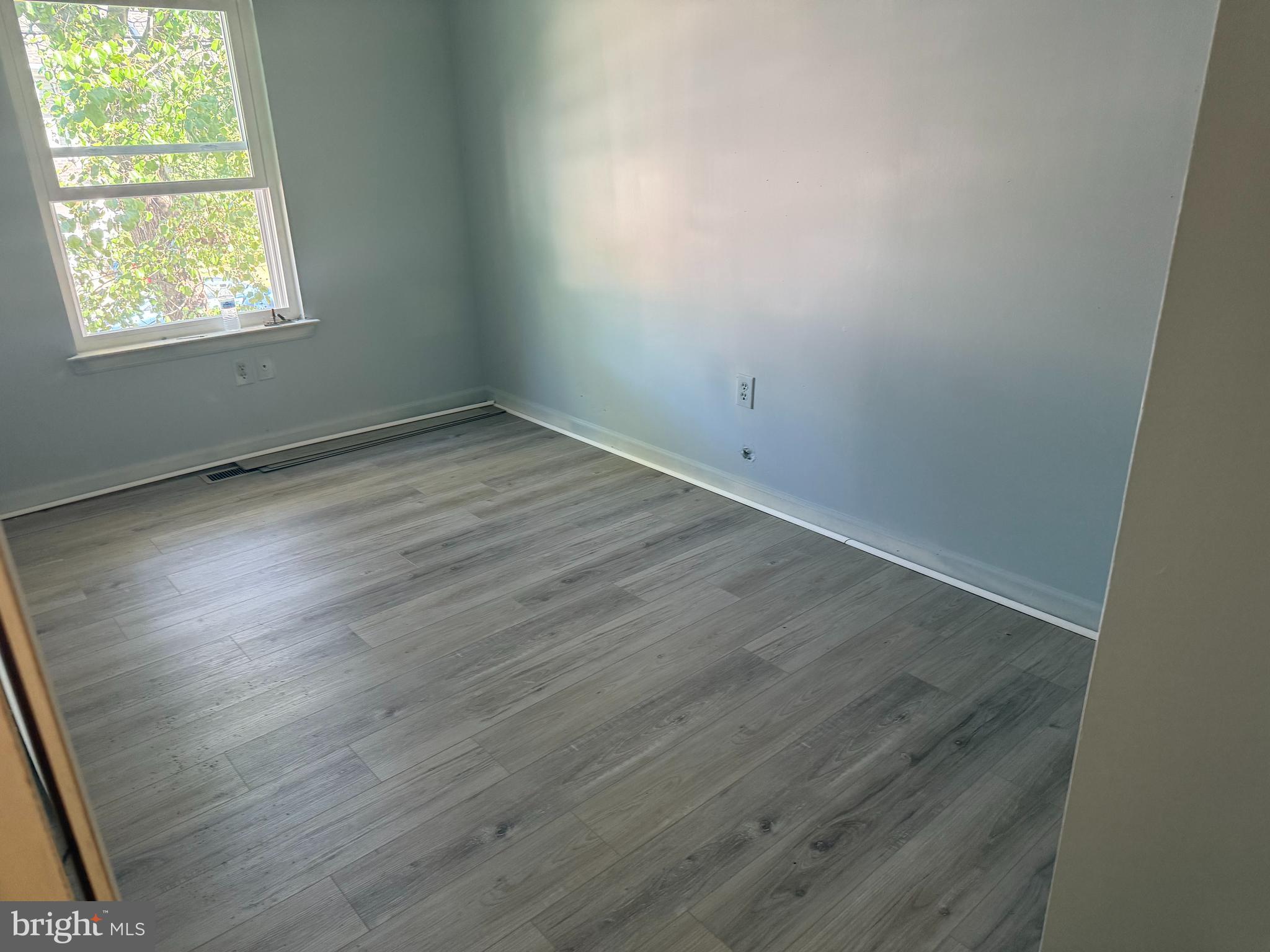 423 Calvert Street Chestertown, MD 21620 - Photo 15 of 20 an empty room with wooden floor and windows