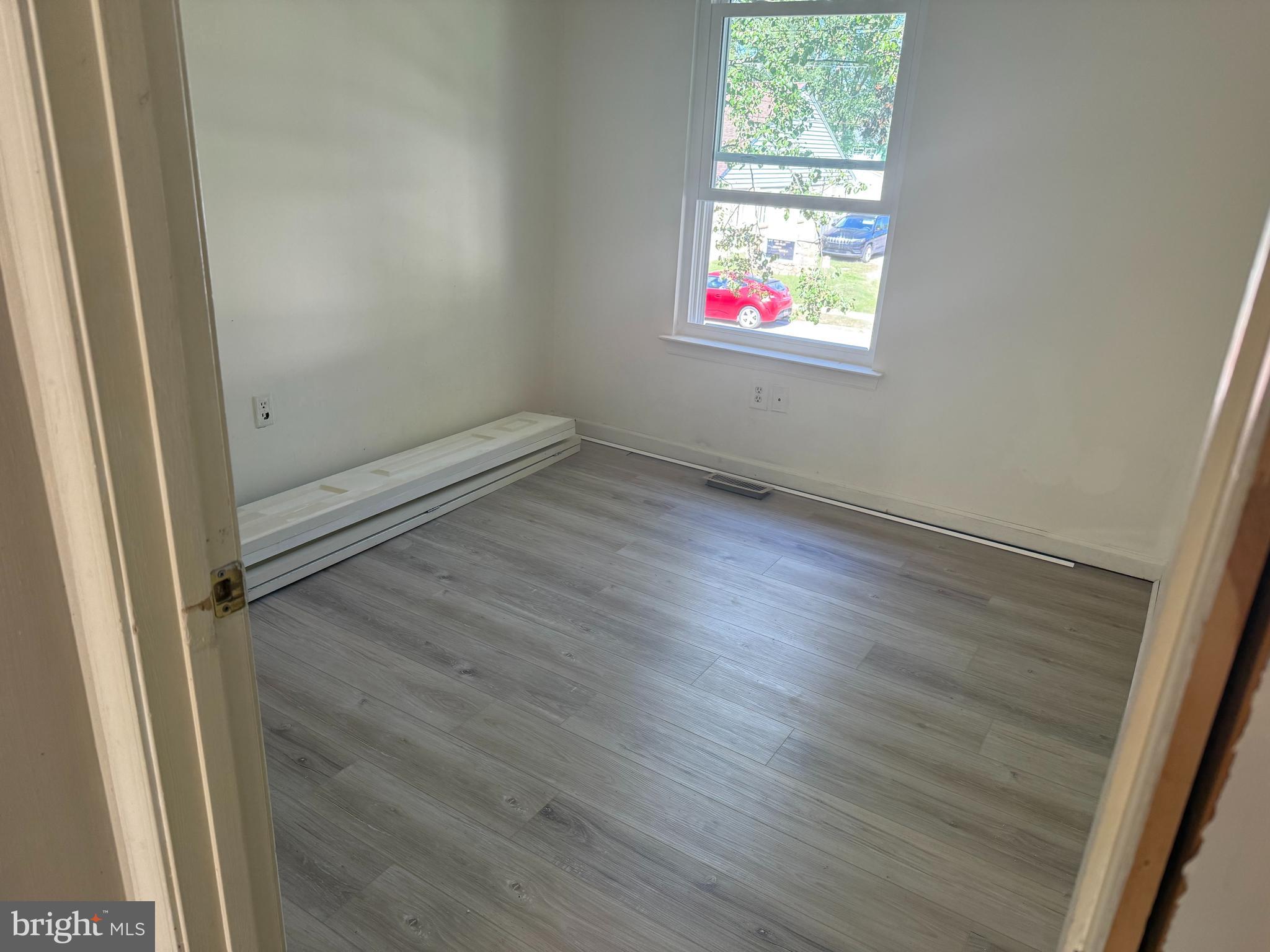 423 Calvert Street Chestertown, MD 21620 - Photo 18 of 20 an empty room with wooden floor and windows