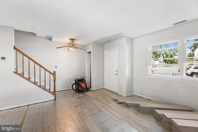 a view of a livingroom with wooden floor and a window