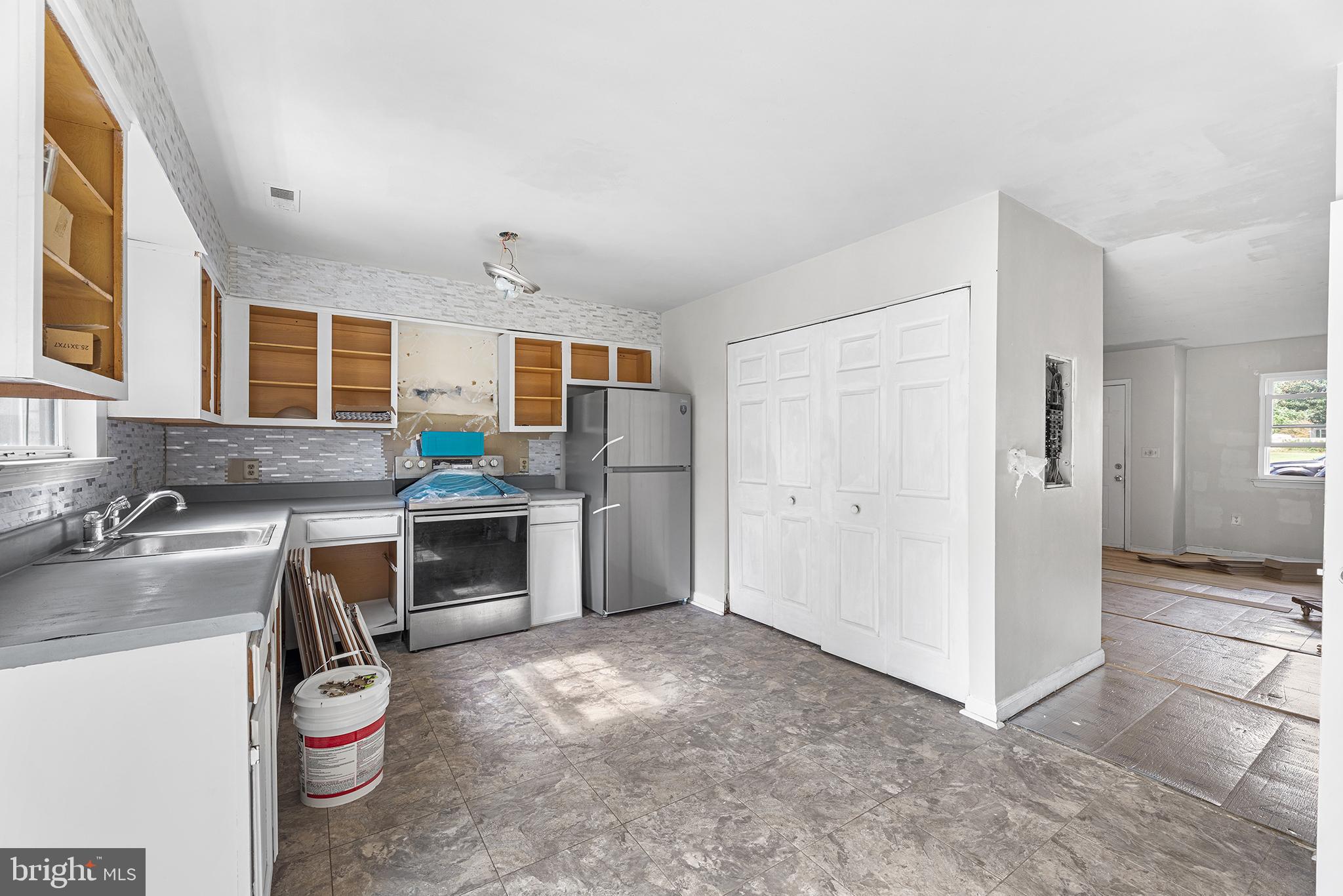 423 Calvert Street Chestertown, MD 21620 - Photo 6 of 20 a kitchen with a sink refrigerator and stove