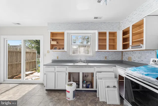 a kitchen with a sink stove and cabinets