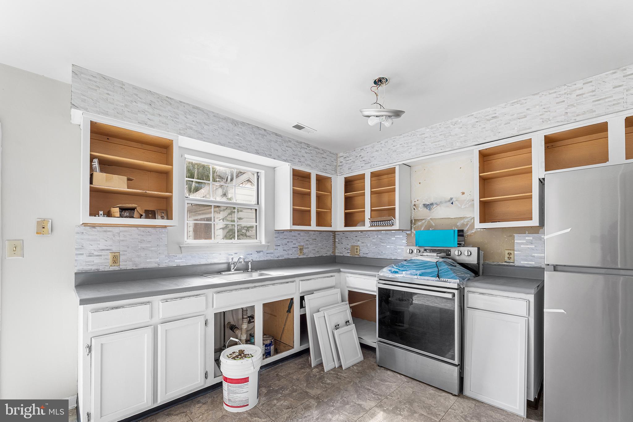 423 Calvert Street Chestertown, MD 21620 - Photo 9 of 20 a kitchen with a sink stove and refrigerator